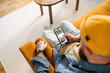 © DZ FILM/Stocksy - A man uses a mobile phone at home
