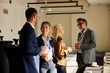 © Boris Jovanovic/Stocksy - Coworkers converse during a break in the seminar