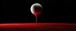 © zhuan - Close Up Golf Ball on Red Tee with Dramatic Lighting Black Background Sport Recreation Game Outdoors