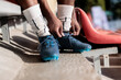 © Jovo Jovanovic/Stocksy - Low section of soccer player tying shoelace
