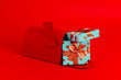 © Juan Moyano/Stocksy - gifts tied with satin ribbons in a red mailbox