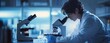 © zhuan - Scientist in Laboratory Examining Sample with Microscope in Focused Research Environment