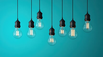 Poster - Vintage-style Edison light bulbs glowing softly against a soothing turquoise background, setting a creative and artistic mood.