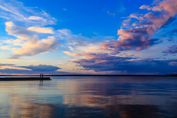 Wall Mural - the sky is blue with a few clouds and the water is calm