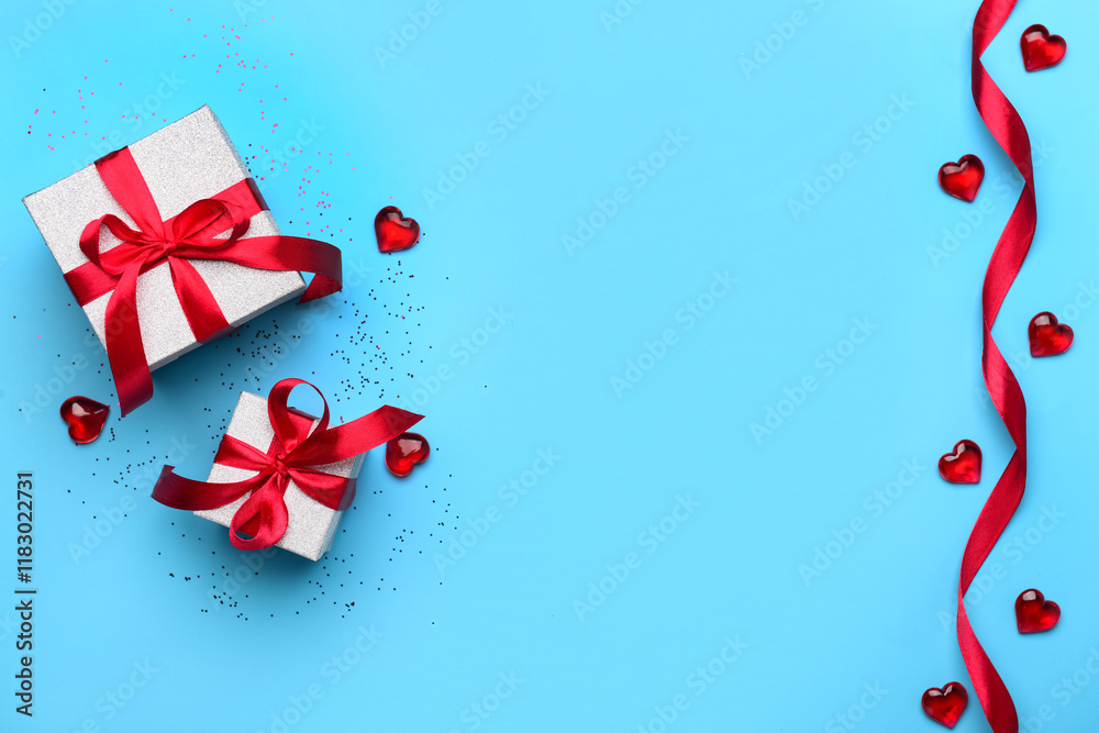 Composition with gift boxes, hearts and ribbon for Valentine's Day celebration on blue background