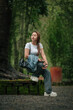 © Saddha Visual - Happy Woman in Casual Outfit Enjoying a Peaceful Forest Setting Outdoors
