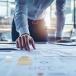 © STwul - Businessman reviewing documents and data on a table.