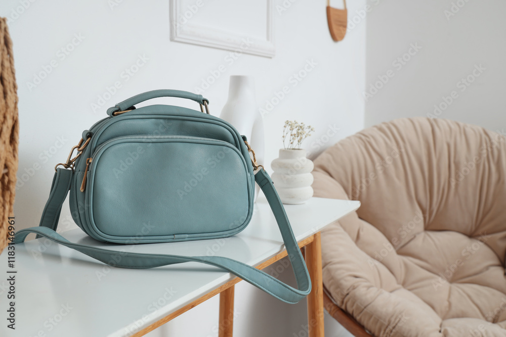 Blue bag on table in light room, closeup