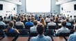 © VistaVisions - Audience with blurred speaker giving presentation in bright university workshop lecture hall background. Scientific conference presentation event, training, meeting