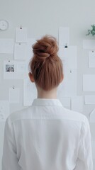 Poster - A person gazing at a vision board filled with inspiring images and quotes, their eyes lit with determination, their environment minimalist and serene