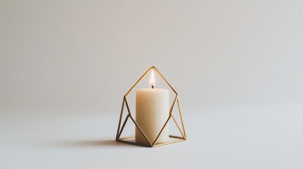 Poster - a modern geometric candlestick in matte gold, holding a small ivory candle, centered on a white back