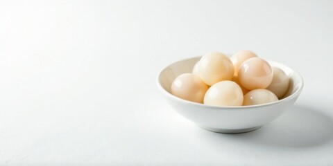Poster - Creamy Round Objects in a White Bowl on a Table
