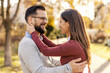 © Dusan Petkovic - Young affectionate couple in love hugging and smiling at each other in city park.