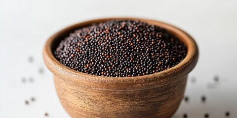 Poster - Black mustard seeds in a full pot against a white background, showcasing the rich and vibrant appearance of black mustard seeds from a front view. The black mustard seeds are prominently displayed.