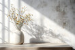 © Jack - A minimalist neutral home interior design featuring a white concrete wall, a beige wooden table adorned with a vase and meadow flower bouquet, and an empty background with ample copy space