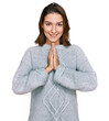 © Krakenimages.com - Young caucasian girl wearing casual clothes praying with hands together asking for forgiveness smiling confident.