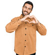 © Krakenimages.com - Young hispanic man wearing casual clothes smiling in love doing heart symbol shape with hands. romantic concept.