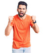 © Krakenimages.com - Young handsome man with beard wearing casual t-shirt angry and mad raising fists frustrated and furious while shouting with anger. rage and aggressive concept.