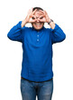 © Krakenimages.com - Middle age arab man wearing glasses over isolated background doing ok gesture like binoculars sticking tongue out, eyes looking through fingers. Crazy expression.