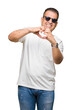 © Krakenimages.com - Middle age arab man wearig white t-shirt and sunglasses over isolated background smiling in love showing heart symbol and shape with hands. Romantic concept.