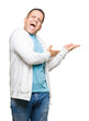 © Krakenimages.com - Middle age arab man wearing sweatshirt over isolated background Pointing to the side with hand and open palm, presenting ad smiling happy and confident