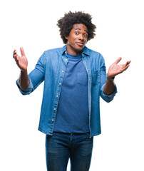 Wall Mural - afro american man over isolated background clueless and confused expression with arms and hands rais