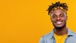 © siraphol - Smiling man in casual outfit with yellow background and headband