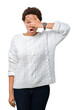 © Krakenimages.com - Beautiful young african american woman wearing sweater over isolated background peeking in shock covering face and eyes with hand, looking through fingers with embarrassed expression.