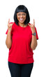 © Krakenimages.com - Beautiful young african american woman wearing glasses over isolated background shouting with crazy expression doing rock symbol with hands up. Music star. Heavy concept.
