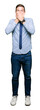 © Krakenimages.com - Handsome business man wearing tie shocked covering mouth with hands for mistake. Secret concept.