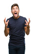 © Krakenimages.com - Young handsome man over isolated background crazy and mad shouting and yelling with aggressive expression and arms raised. Frustration concept.