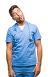 © Krakenimages.com - Young handsome doctor surgeon man over isolated background making fish face with lips, crazy and comical gesture. Funny expression.