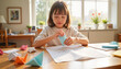 © Alex_Kalin - Young Asian girl crafting math origami in bright sunlit room, creativity