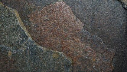 Poster - close-up of textured dark slate stone surface with natural rough patterns and earthy tones for use in background design or texture projects