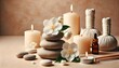 © QasimAli - Zen stones, candles and white flower on beige background witn copy space, wellness and harmony, massage and bodycare, spa and wellness concept