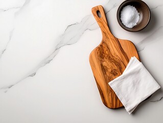 Poster - Overhead view of a marble surface highlighting a wooden chopping board and delicate linen napkin evoking a minimalist culinary still life with high contrast natural lighting
