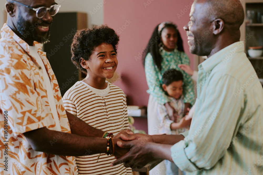 African American father and son shaking hands while little boy looking ...