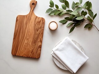 Poster - Overhead view of a rustic wooden cutting board and elegantly folded white linen napkin placed on a marble kitchen counter and bathed in warm natural light creating a bright airy and refined ambiance