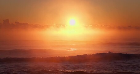 Wall Mural - Golden Sun Rising Over Misty Horizon and Peaceful Ocean Waves, Beautiful Sea Sunrise video
