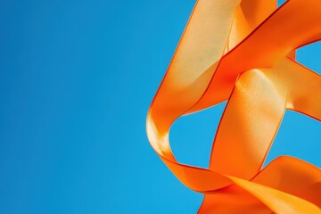 Canvas Print - Orange ribbons flowing against a bright blue sky