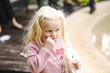 © Austockphoto - Little girl chewing on hair of doll looking thoughtful