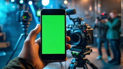 Aufkleber - a person holds a smartphone displaying a green screen while a camera is prepared for filming. two ad