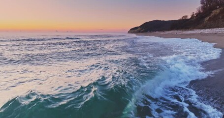 Wall Mural - flying over rolling waves to the wild beach shore, beautiful sea sunrise sunset landscape
