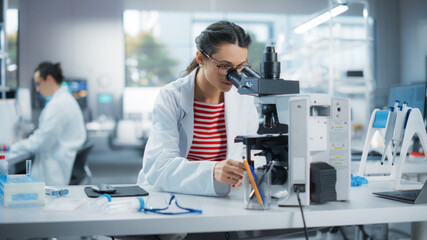 Aufkleber - Portrait of a Smart Female Student Working on Laptop on a Research Project in School. Medical Research Scientist Looking at Biological Samples Under a Microscope in an Applied Science Laboratory