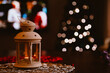 © Austockphoto - Small indoor lantern with Christmas tree in background creating bokeh light effect