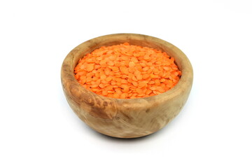 Wall Mural - Red lentils in a wooden bowl isolated on white background. Red lentils pile isolated. Dry orange lentil grains, round heap of dal, spilled raw daal, dhal, masoor on white 