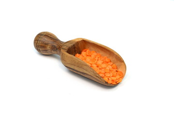 Wall Mural - Red lentils in a wooden scoop isolated on white background. Red lentils pile isolated. Dry orange lentil grains, round heap of dal, spilled raw daal, dhal, masoor on white 