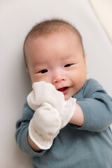 Wall Mural - Close view of infant hands covered in mittens