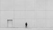 © musa - Man in suit facing a large blank wall with a single door.