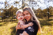 © Austockphoto - Cultural image of First nations Australian mother carrying son together on country